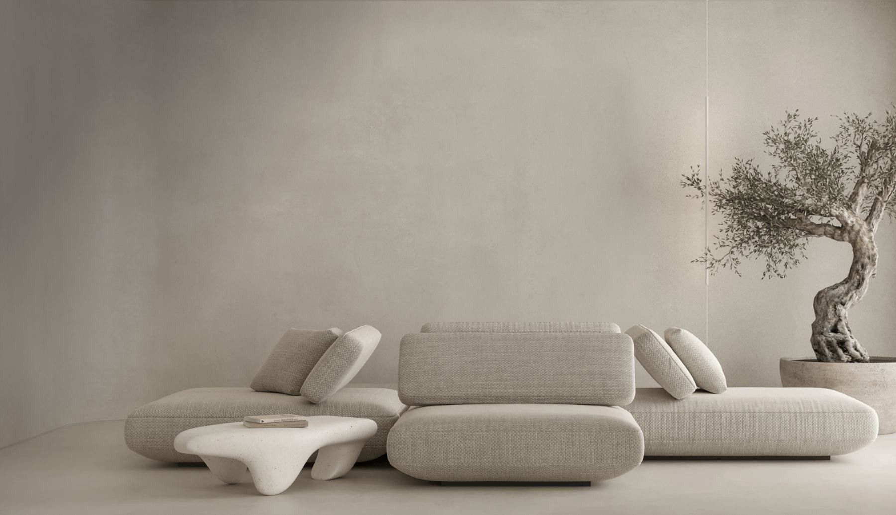 Low modular sofa in bouclé with an olive tree against a limewash wall