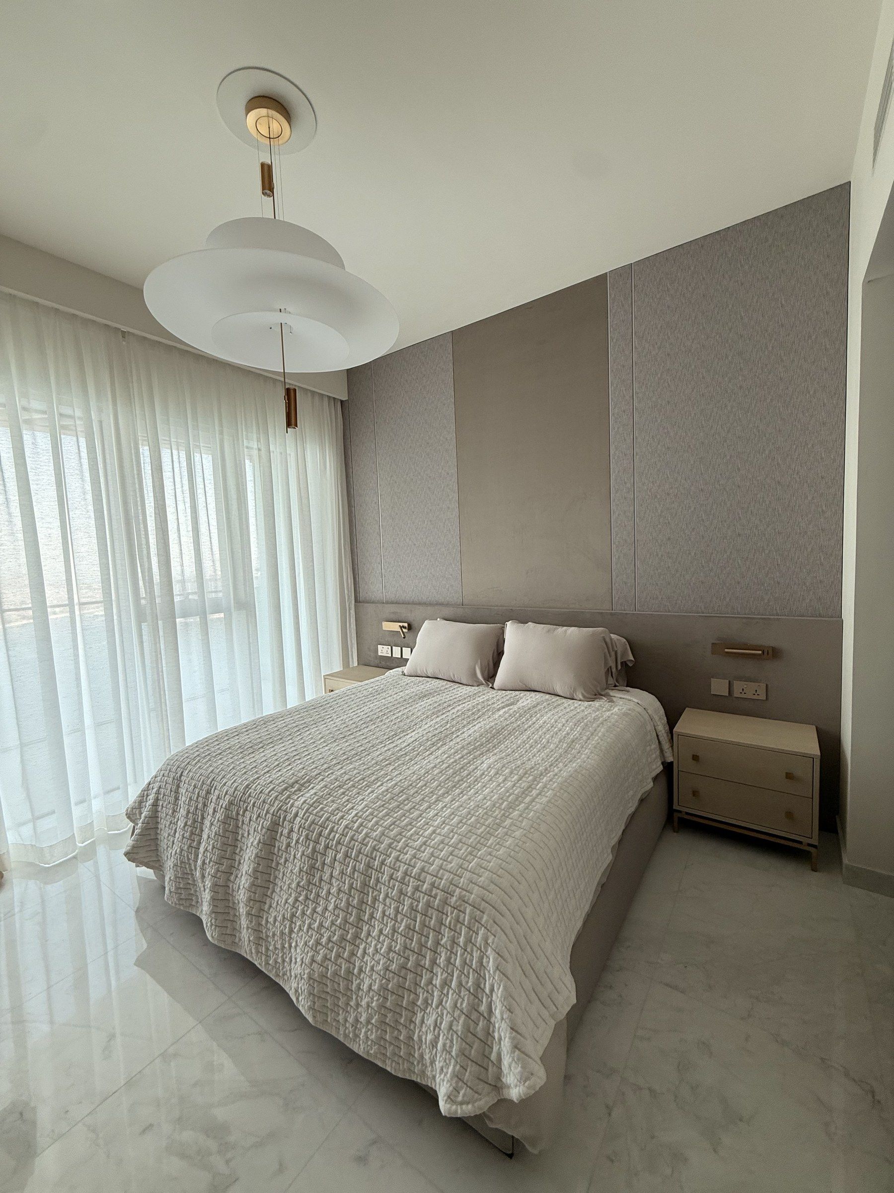 Bedroom with an upholstered textile headboard wall