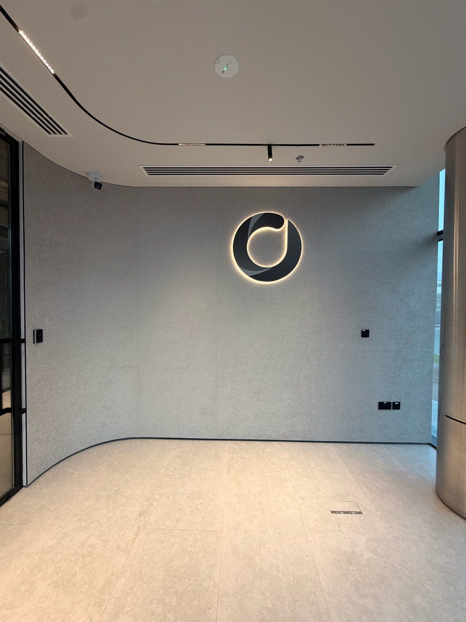 Curved reception wall in textile with a ring light logo, Fujairah