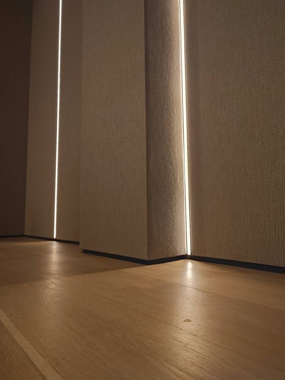 Textile wall panels with a recessed vertical light slot